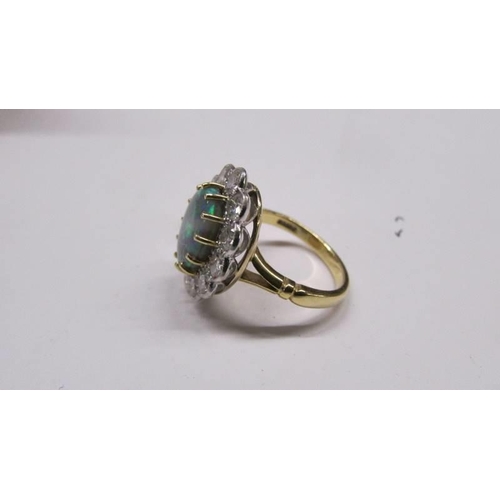 2030E - An 18ct gold opal and diamond ring, size M, total weight 6.8 grams.