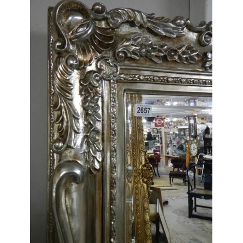 2657 - A large bevel edged mirror in gilded double swept frame, 92 x 176 cm. COLLECT ONLY.