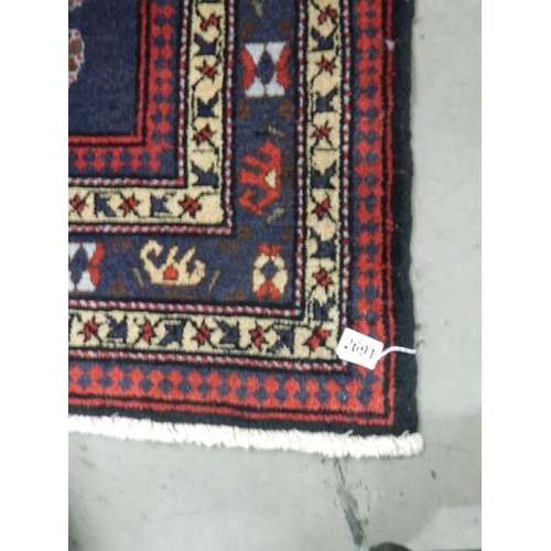 2691 - A vintage Persian red wool rug, Approximately 128 x 178 cm, COLLECT ONLY.