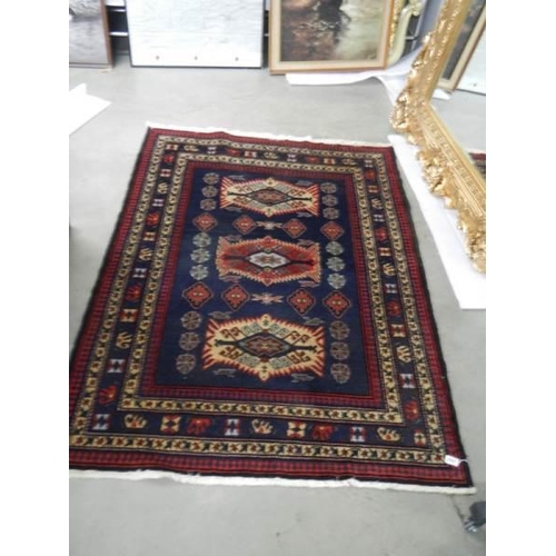 2691 - A vintage Persian red wool rug, Approximately 128 x 178 cm, COLLECT ONLY.