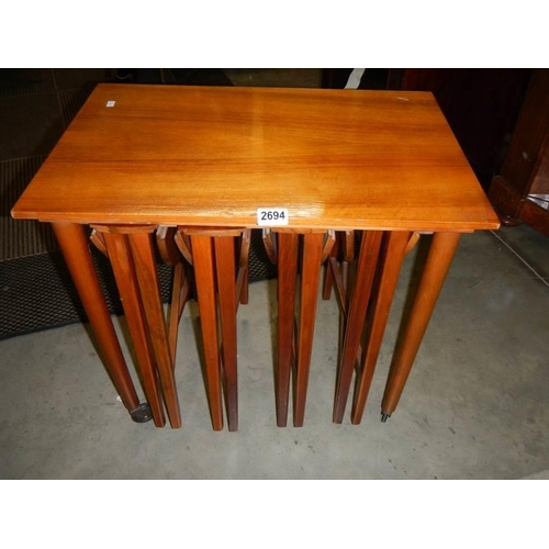 2694 - A nest of four teak drop side tables, COLLECT ONLY