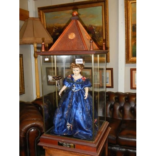 2696 - A good quality 20th century doll in architectural style case. COLLECT ONLY.