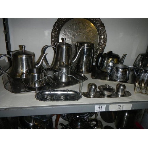 15 - Three shelves of assorted metal ware including tea sets, trays etc., COLLECT ONLY.