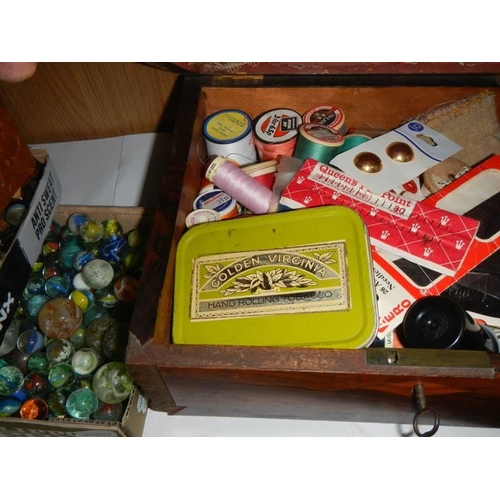 126 - A mahogany box, marbles, buttons etc.,