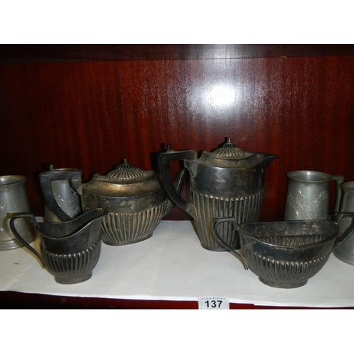 137 - A silver plate teaset and a quantity of tankards.