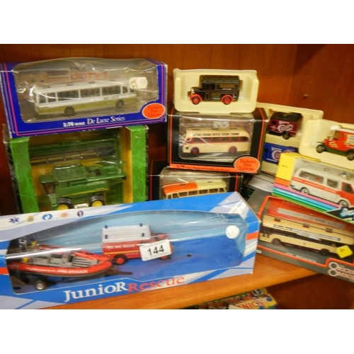 144 - A quantity of boxed die cast models including buses.