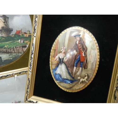 184 - Two gilt framed oval plaques and a gilt framed windmill scene.