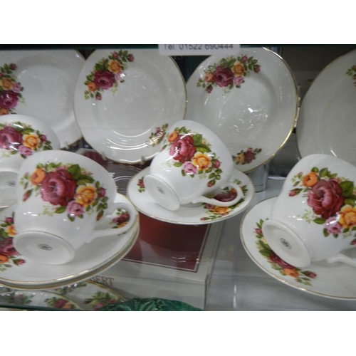 185 - A pretty rose decorated tea set.