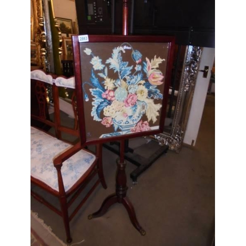 2863 - A 19th century mahogany pole screen with tapestry panel and brass feet, Approximately 136 cm tall.