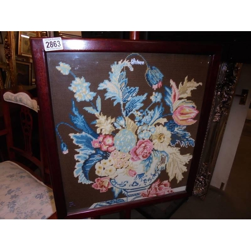 2863 - A 19th century mahogany pole screen with tapestry panel and brass feet, Approximately 136 cm tall.