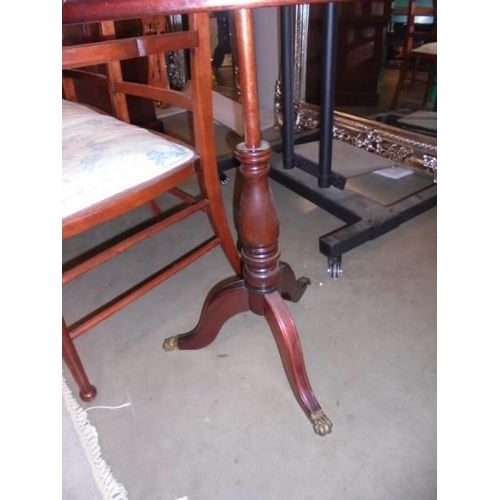 2863 - A 19th century mahogany pole screen with tapestry panel and brass feet, Approximately 136 cm tall.