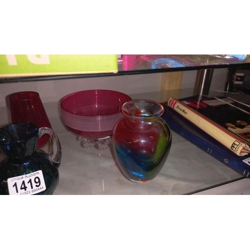 1419 - A quantity of art glass and a cranberry bowl on feet