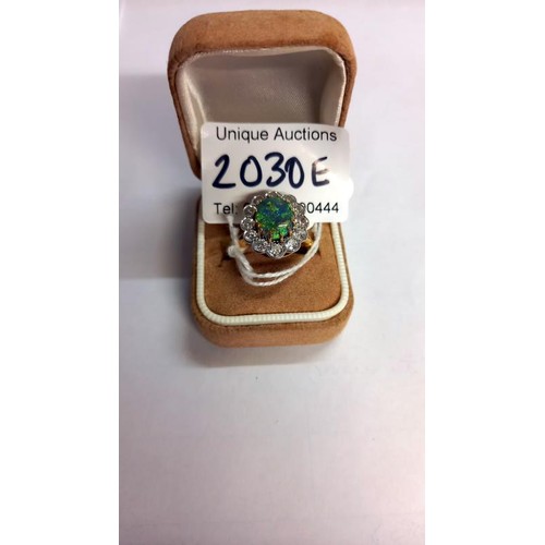 2030E - An 18ct gold opal and diamond ring, size M, total weight 6.8 grams.