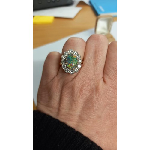 2030E - An 18ct gold opal and diamond ring, size M, total weight 6.8 grams.