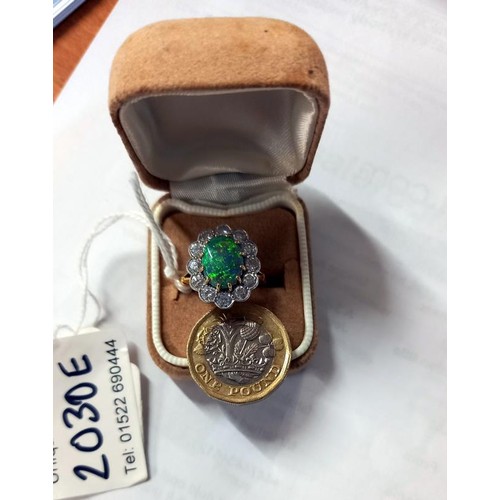 2030E - An 18ct gold opal and diamond ring, size M, total weight 6.8 grams.