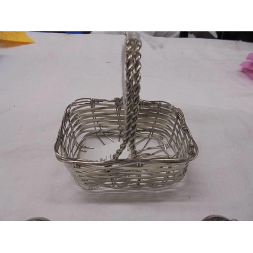 1035 - A silver plate basket and six silver plate place card holders in the shape of apples.