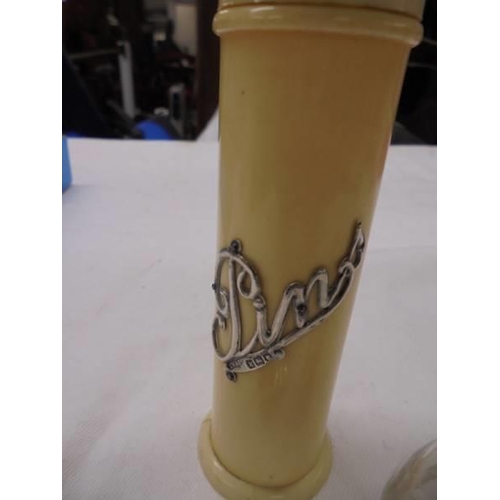 1038 - A silver topped scent bottle, a silver scoop and a pin pot with silver lettering.