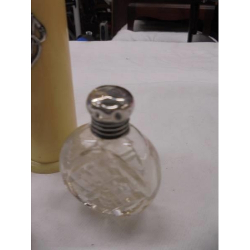 1038 - A silver topped scent bottle, a silver scoop and a pin pot with silver lettering.