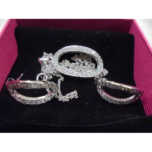 1048 - Two good quality silver pendants with matching earrings.