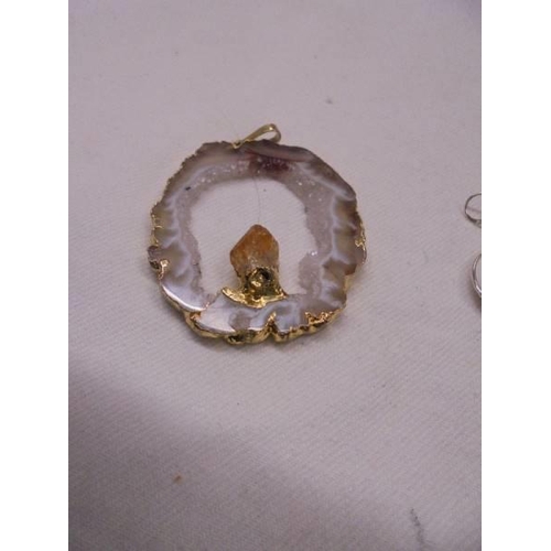 1058 - A mother of pearl pendant with matching earrings and two crystal pendants.