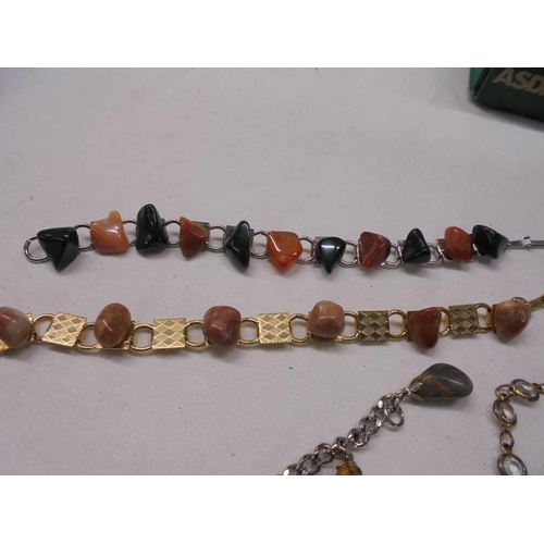 1060 - A mixed lot of natural stone bracelets, pendants and earrings etc.,