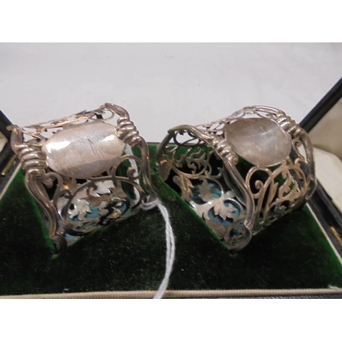 1064 - A cased pair of silver napkin rings, Birmingham 1914. 1 A/F