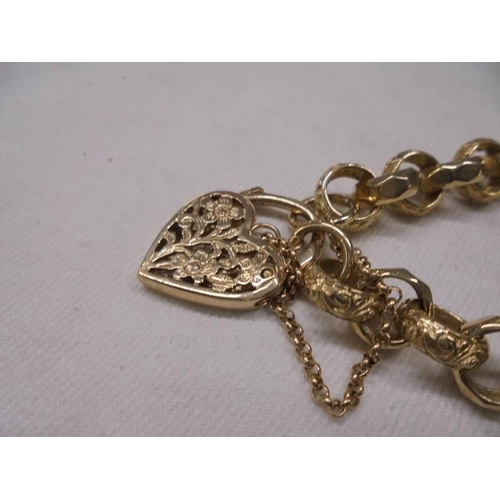 1067 - A decorative 9ct gold bracelet with ornate gold padlock and safety chain, 31.8 grams.
length 20cm