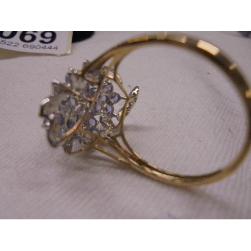 1069 - A 9ct gold ring set multiple blue stones, size U, 3 grams.