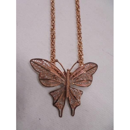 1082 - A 9ct rose gold necklace in the form of a butterfly, 11 grams