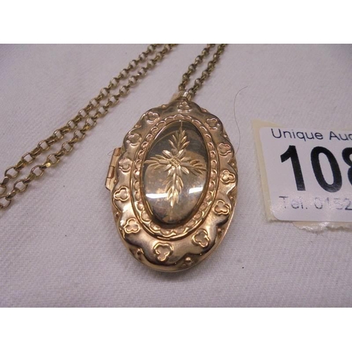 1085 - A 9ct gold locket on a 9ct gold chain, 12 grams.