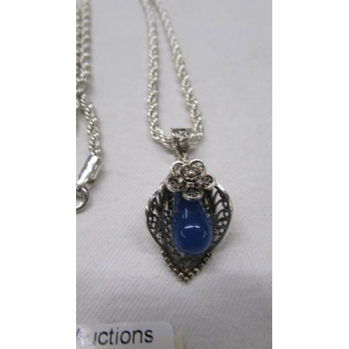 1103 - A silver pendant on heavy silver chain, 31 grams.