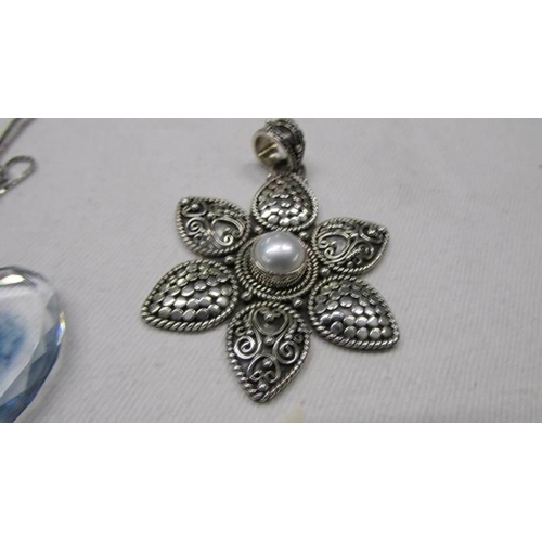 1105 - A glass pendant on a silver chain (chain 2.6 grams) and a silver pendant (20.4 grams)