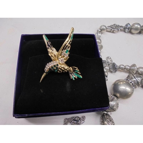 1111 - A Kingfisher brooch, a bow brooch set pearls, necklaces etc.,