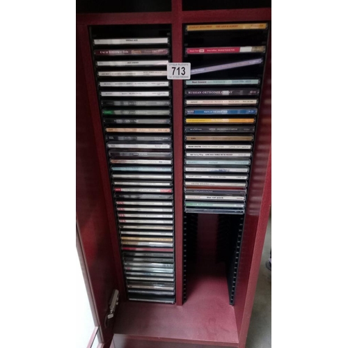 713 - A Cabinet & a quantity of  mixed CD's