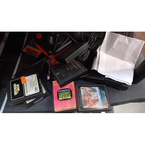 1205 - Atari CX 2600 game console with power lead, controllers and an array of game cartridges including Pa... 