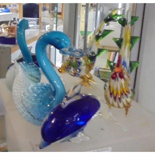 1252 - Four glass bird and dolphin paperweights and five other paperwieghts.