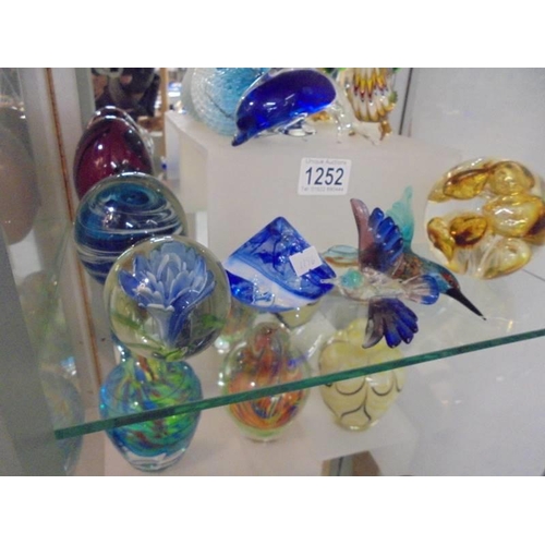 1252 - Four glass bird and dolphin paperweights and five other paperwieghts.