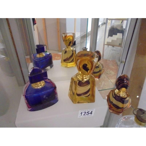 1254 - Four coloured glass scent bottles and two clear glass examples.