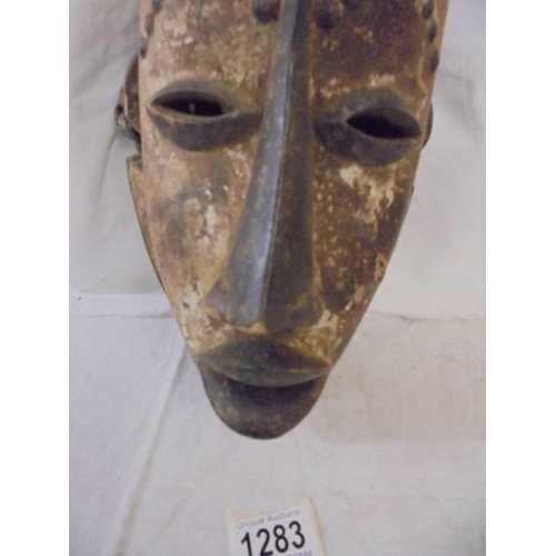 1283 - An carved wood tribal mask.