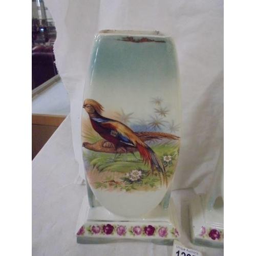 1297 - A pair of ceramic cases hand painted with pheasants.