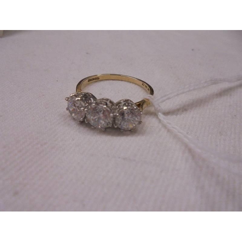 1140 - An 18ct gold three stone ring, size Q, 3.3 grams.