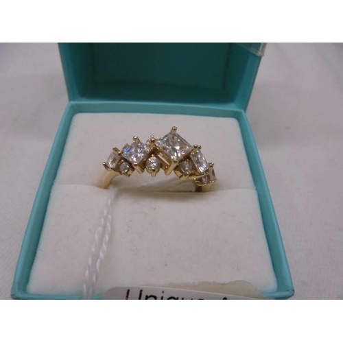 1142 - An 18ct gold ring set clear stones, size S, 4.1 grams.