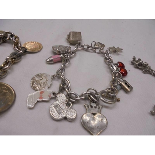 1143 - 3 charm bracelets - 1 with coins, 1 with 925 St. Christopher and a gate bracelet with 925 silver hea... 