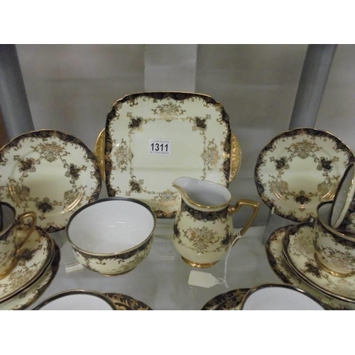 1311 - A pretty 21 piece porcelain tea set, COLLECT ONLY.