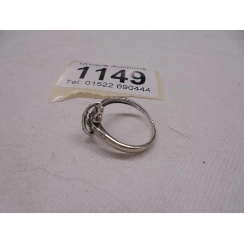 1149 - A diamond ring fashioned as a crossover in 9ct white gold, size K half, 2.2 grams.