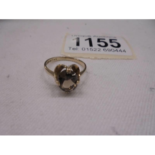 1155 - A Smoky quartz ring in 9ct gold dated 1980. Size L, 2 grams.