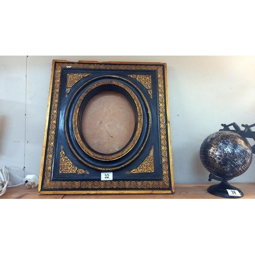 32 - A 'Carvers and Gilders' ormalu and black picture frame 45cm x 50cm, oval 19cm x 24cm COLLECT ONLY