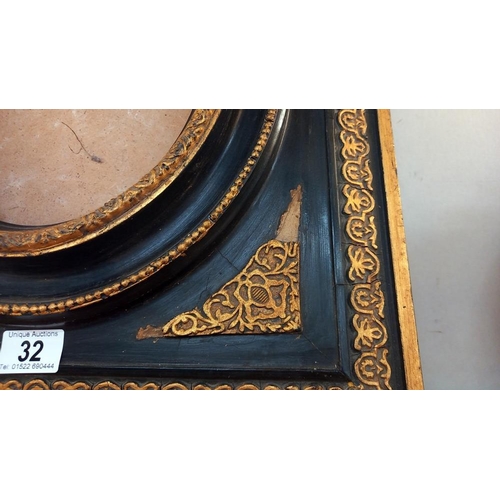 32 - A 'Carvers and Gilders' ormalu and black picture frame 45cm x 50cm, oval 19cm x 24cm COLLECT ONLY