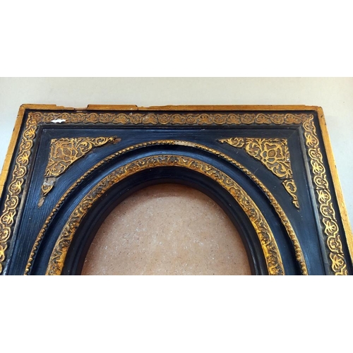 32 - A 'Carvers and Gilders' ormalu and black picture frame 45cm x 50cm, oval 19cm x 24cm COLLECT ONLY