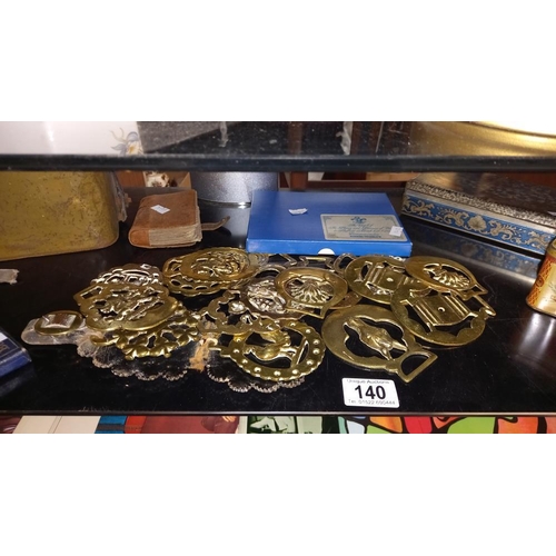 140 - A quantity of horse brasses, leather collar box, old tins, one containing buttons, etc